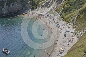 Durdle Door - people chilling on the beach.