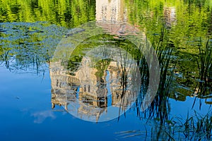 Durham Cathedral reflection on water, river wear with lush green trees