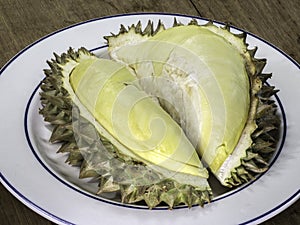 Durian on dish and on wooden table, thai fruit