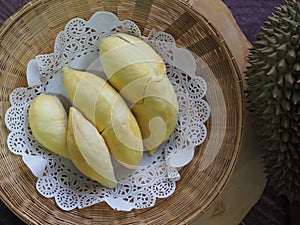 Durian fruit - durian on white paperon bamboo weave tray