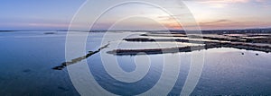 Dusk aerial panoramic seascape view of Olhao salt marsh Inlet.