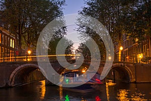 Dusk on the Amsterdam Canal and a Boat Under the Bridge