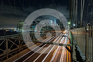 Dusk busy traffic over Brooklyn Bridge with Lower Manhattan Skyline, New York United States