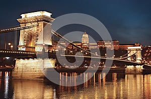 Dusk cityscape of the Chain bridge across the river Danube with the Buda castle in the background in the Hungarian capital Budape