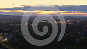 Dusk Cityscape of Krakow with Glowing Sky, Elevated view of Krakow city lights as night falls, with a striking sunset