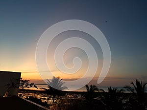 Dusk Delight View with Blue Sky and Palm Silhouette