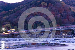 A dusk landscape of Togetsukyo bridge in Kyoto in autumn telephoto shot