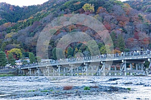 A dusk landscape of Togetsukyo bridge in Kyoto in autumn telephoto shot