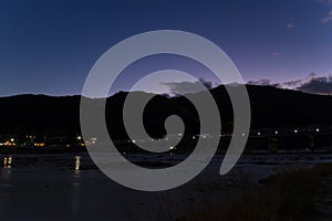 A dusk landscape of Togetsukyo bridge in Kyoto in autumn wide shot