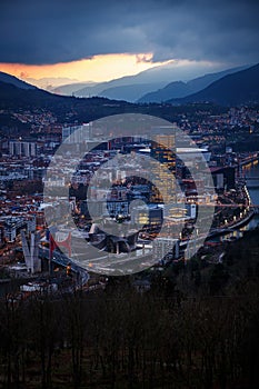 Dusk, twilight over Bilbao city in Basque Country, Spain. Town between mountains.