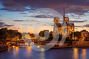 Dusk view of the River Seine and Notre Dame cathedral in Paris France