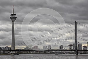 Dusseldorf City skyline, communication tower and bridge next to Rhine River (Germany)