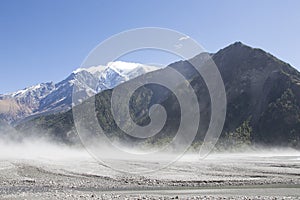 Dust being picked up by katabatic wind blowing through a dried river bed along the Annapurna Circuit, Nepal photo