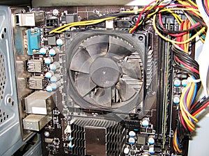 Dust on the computer pc processor cooler with mainboard and computer case fragment