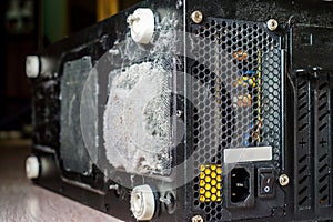 Dust on the computer processor cooler with mainboard and computer case fragment. Selective focus