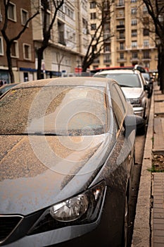Dust and dirt on a car due to a sand storm arriving from the sahara in Madrid