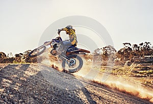 Dust, race and man on dirt bike in desert with adventure, adrenaline and speed in competition, Extreme sport, trick and
