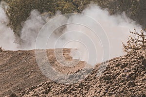 A dust storm. Powdered dust and sand flowing into air on a gravel road.