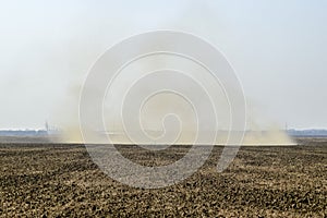 Dust storm. Tornado in the field. Clubs of dust.