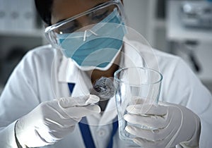 Dusting is delicate business. High angle shot of a female forensic scientist dusting for prints in the lab.