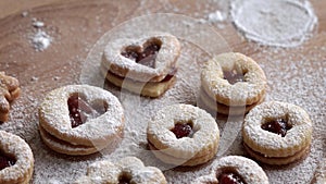 Dusting Linzer Christmas cookies with sugar, closeup