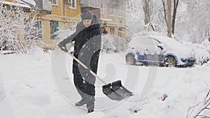 The dusting of snow in the yard with a shovel.