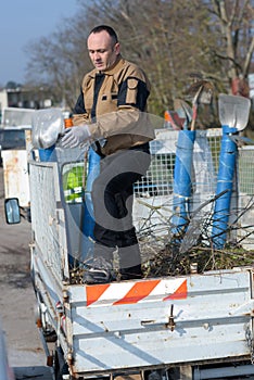 Dustman cleaning lorry bin photo