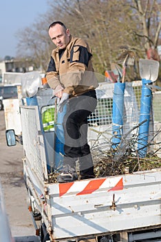 Dustman cleaning lorry bin photo