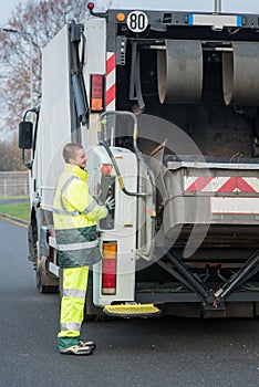 dustman next to lorry bin