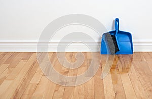 Dustpan and brush on a wooden floor