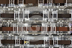 Dusty compact cassettes seen from the side of the tape