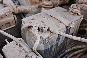 Dusty details of a flat-four boxer car engine compartment under the open hood. Alternator and intake manifold. Closeup