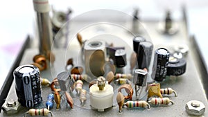 Dusty and dirty vintage electronics background with resisters, capacitors,diodes and other components photo