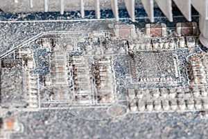 Dusty electronics components on PC printed circuit board