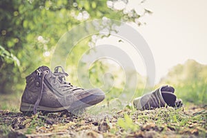 Missing and poverty concept: Abandoned shoe lying on the dusty ground