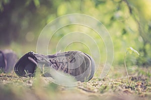 Missing and poverty concept: Abandoned shoe lying on the dusty ground