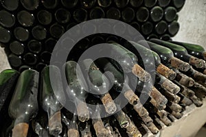 Dusty old wine bottles in an underground wine cellar