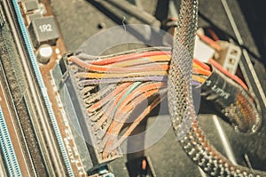 Dusty power wires inside the desktop system unit. A layer of dust and dirt on the insulation cables. Selective focus