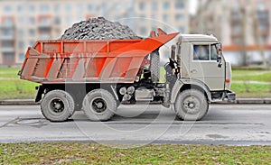 The dusty truck with a red body