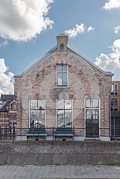 Dutch 18th century classic brick house, with blue sky and white clouds