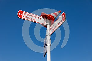 Dutch bike sign pole with directions and distances