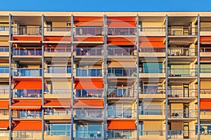 Dutch block of flats with orange sunshades