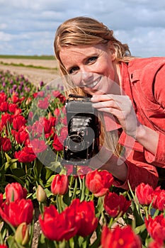 Dutch blond girl with old photo camera