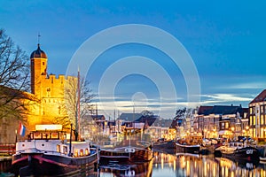 Dutch canal with sailing boats and stronghold tower in the city center of Zwolle