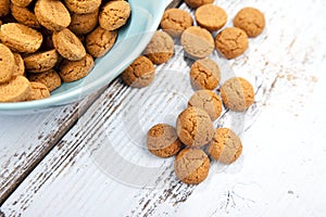 Dutch candy pepernoot with bowl on wooden background