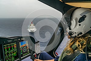 The Dutch Caribbean Coastguard - female pilot over a crusie ship photo