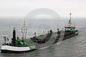 Dutch dredger in in Wadden Sea near Ameland island