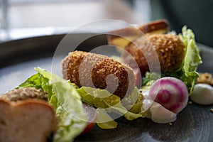 Dutch fast food, deep fried croquettes filled with ground beef meat and served with green salad