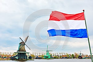 Dutch flag and windmill on canal