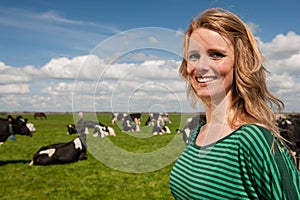 Dutch girl in field with cows photo